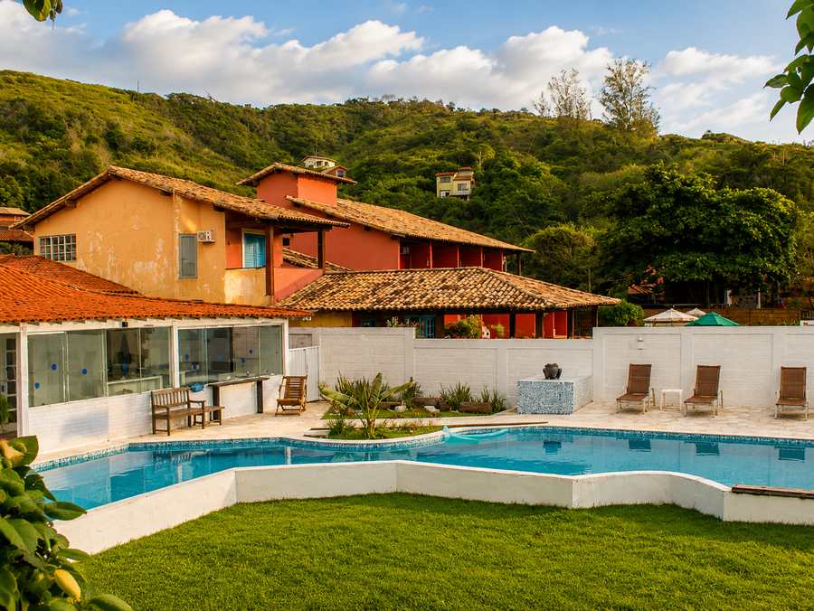 Oceanfront wooden deck with loungers overlooking Tucuns Beach in Búzios